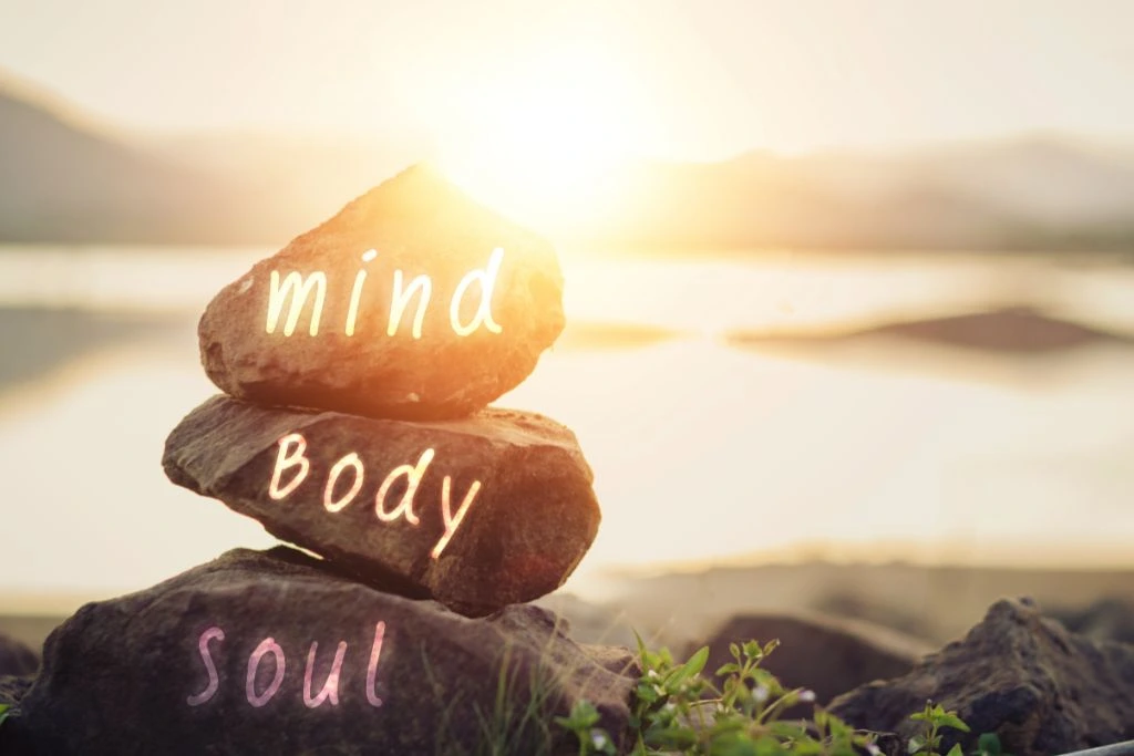 Mind, Body and Soul printed on the stacked rocks