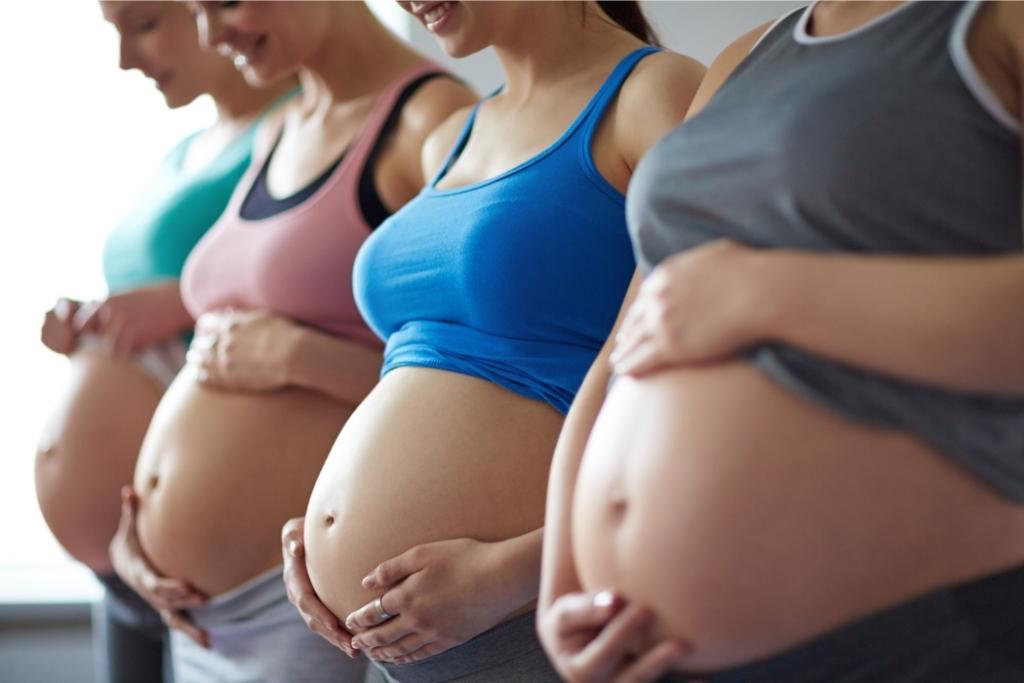 four pregnant women in line