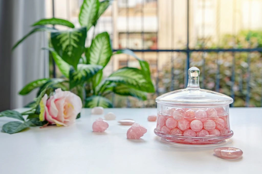 polished rose quartz in a jar of water