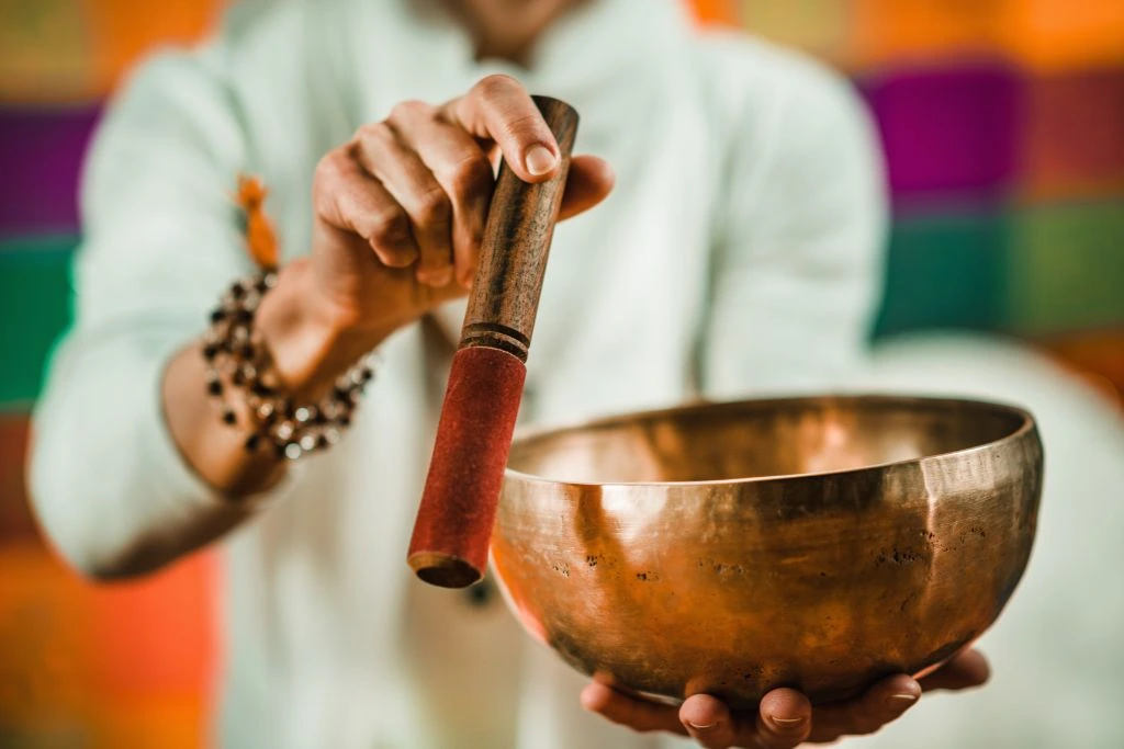 man holding a tibetan singing bowl