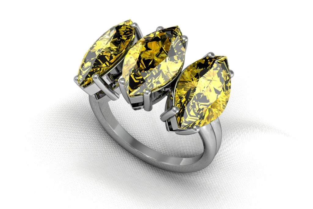 yellow sapphire ring placed on top of a thin white fabric