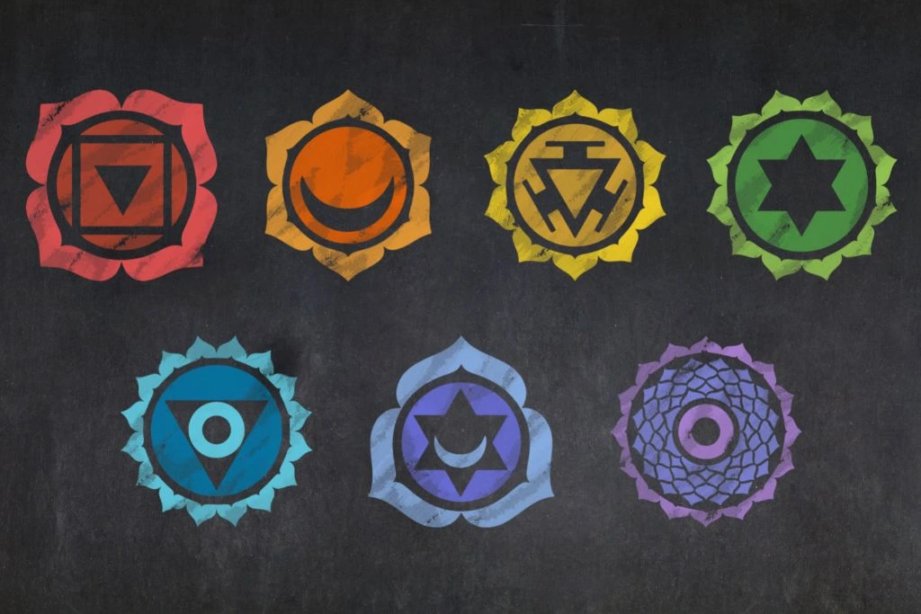 7 chakra symbols on a dark background