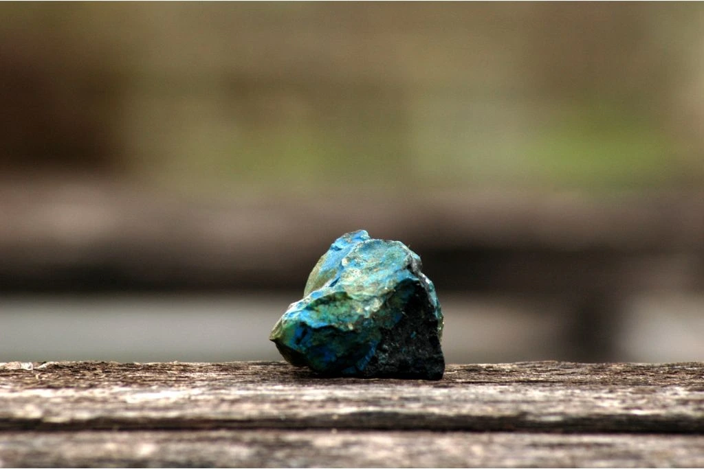 raw malachite on wood
