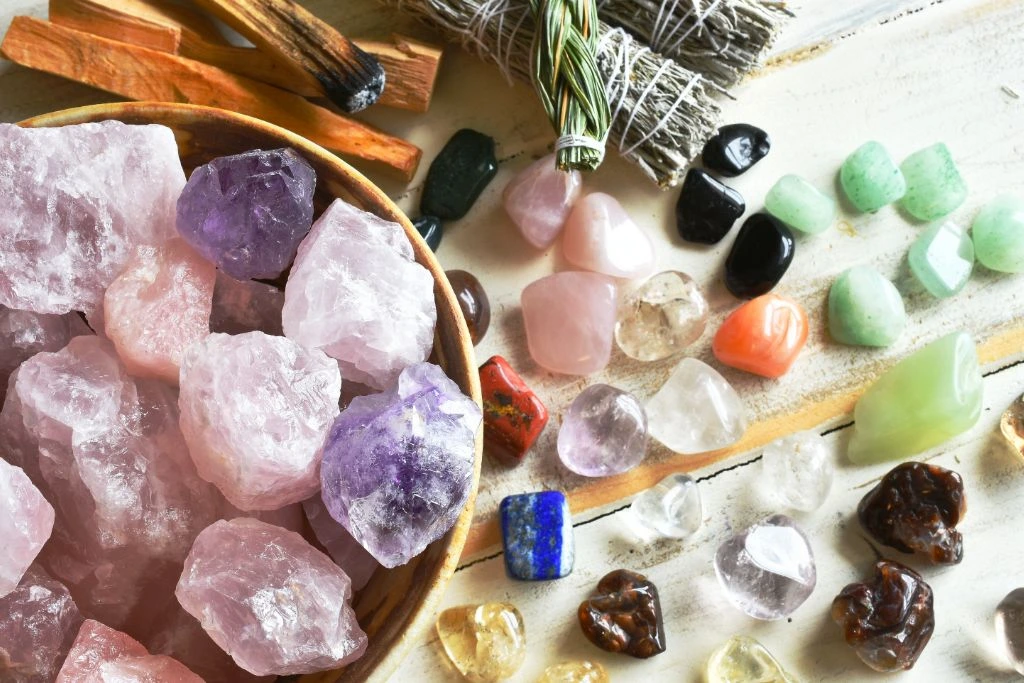 Rose Quartz together with other healing crystals and smudge stick