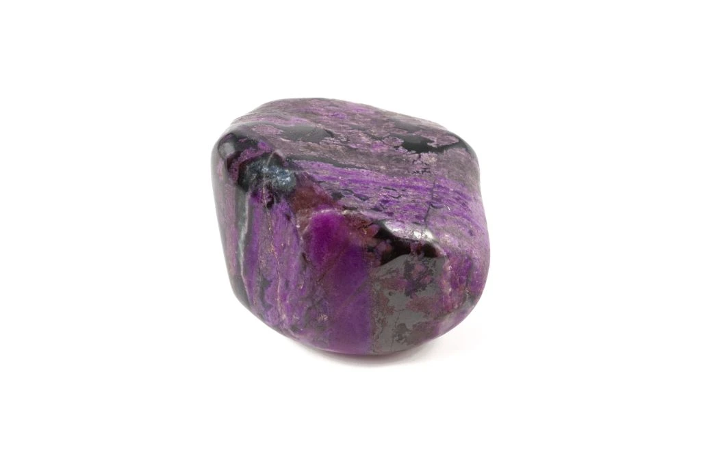 Sugilite crystal on a white background