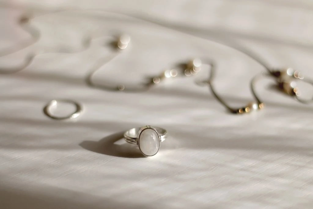 moonstone jewelry pieces situated on a rough like cloth texture