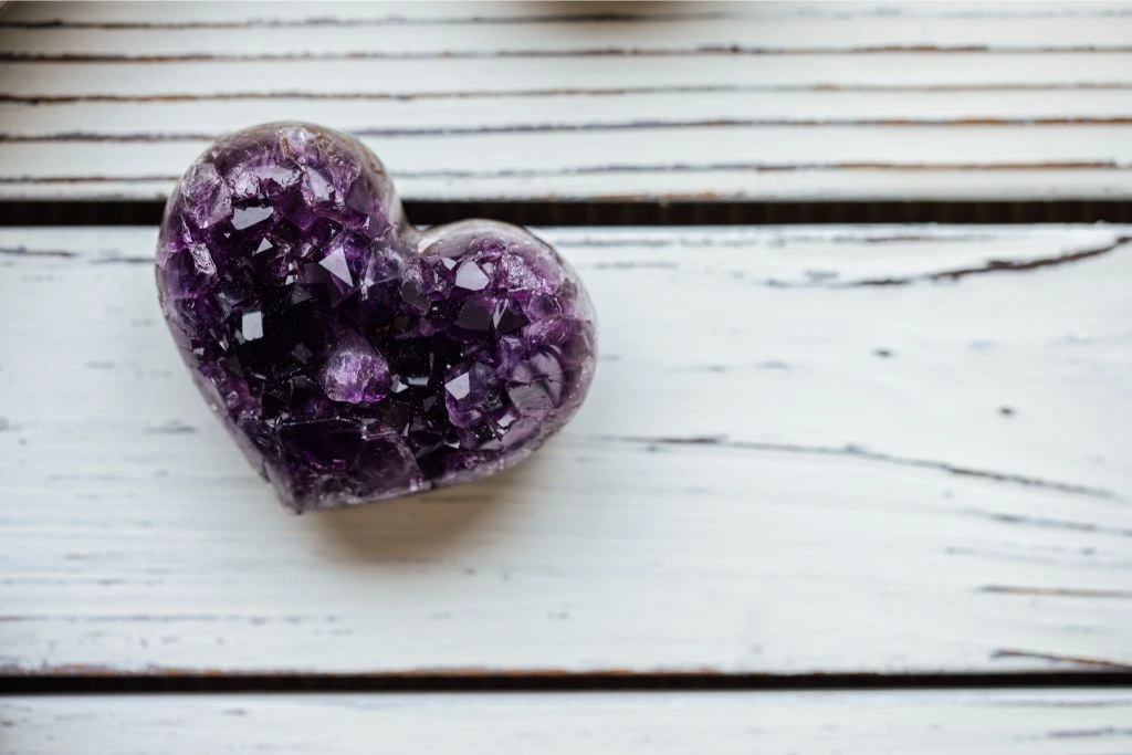 Amethyst Crystal Heart on a table