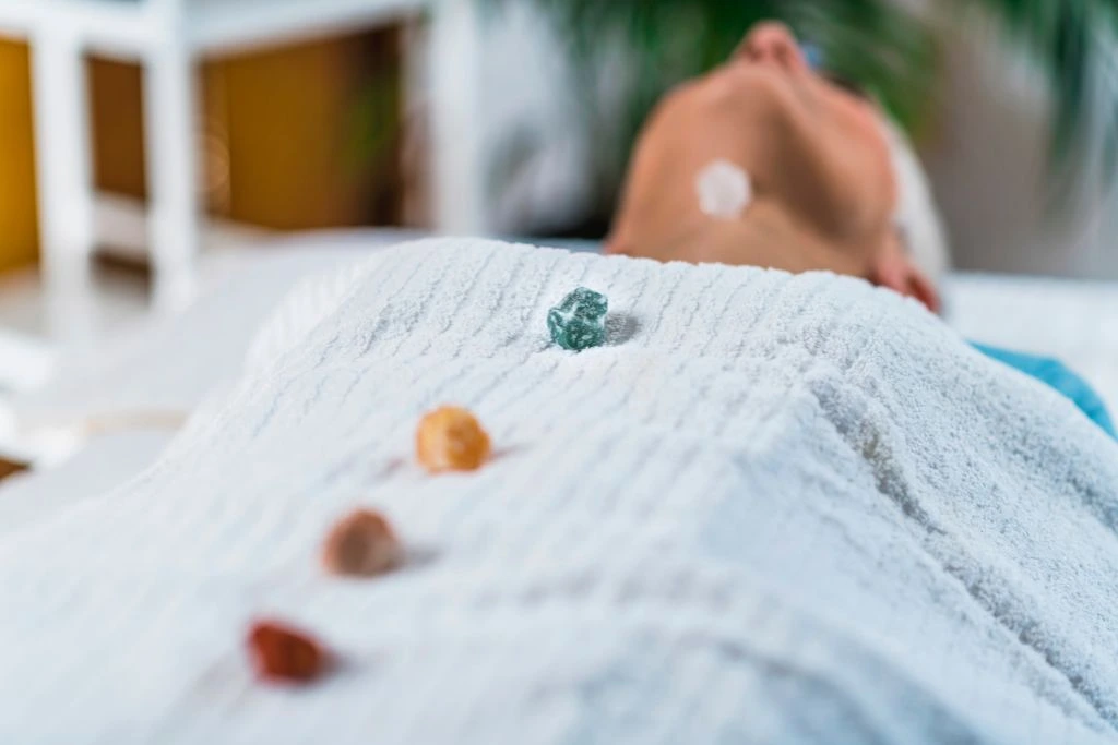 Crystals are placed on the chakra points of a woman