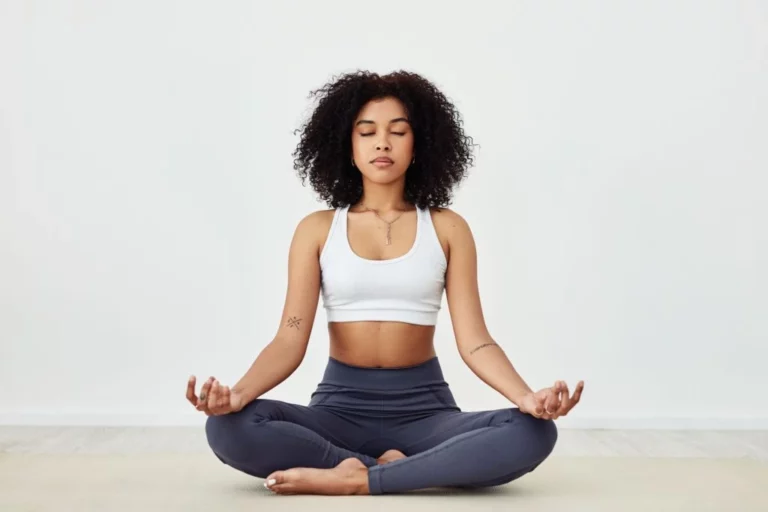 A woman meditating on the floor