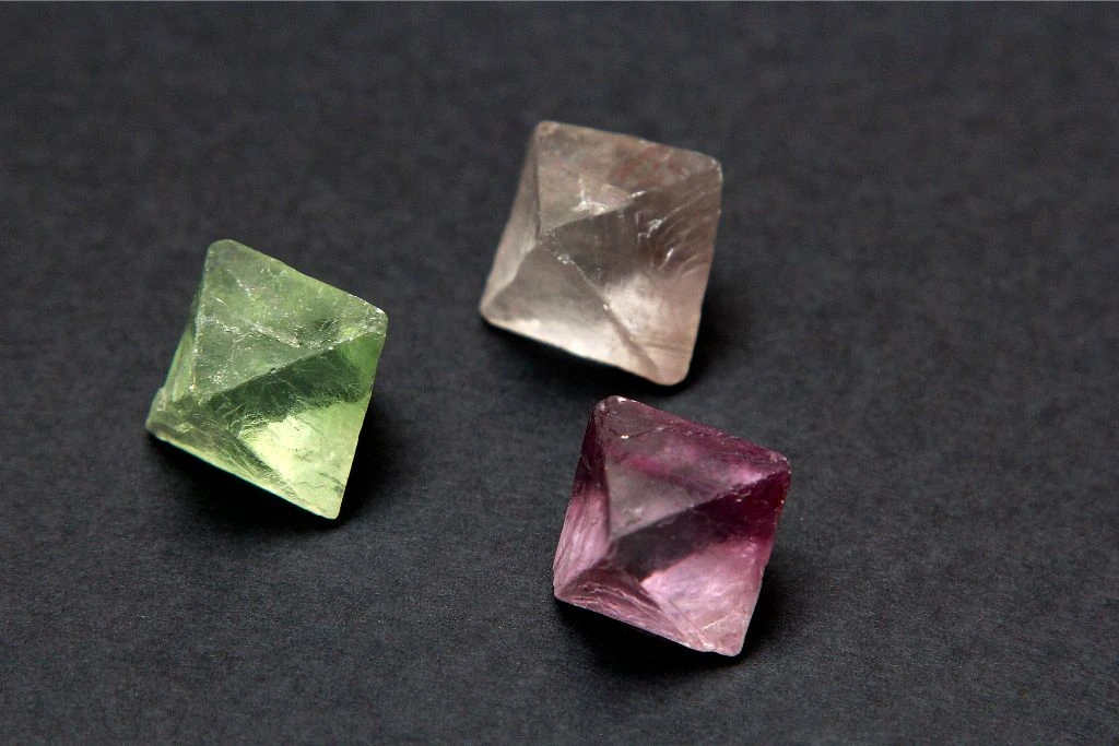3 colors of fluorite crystals in black background
