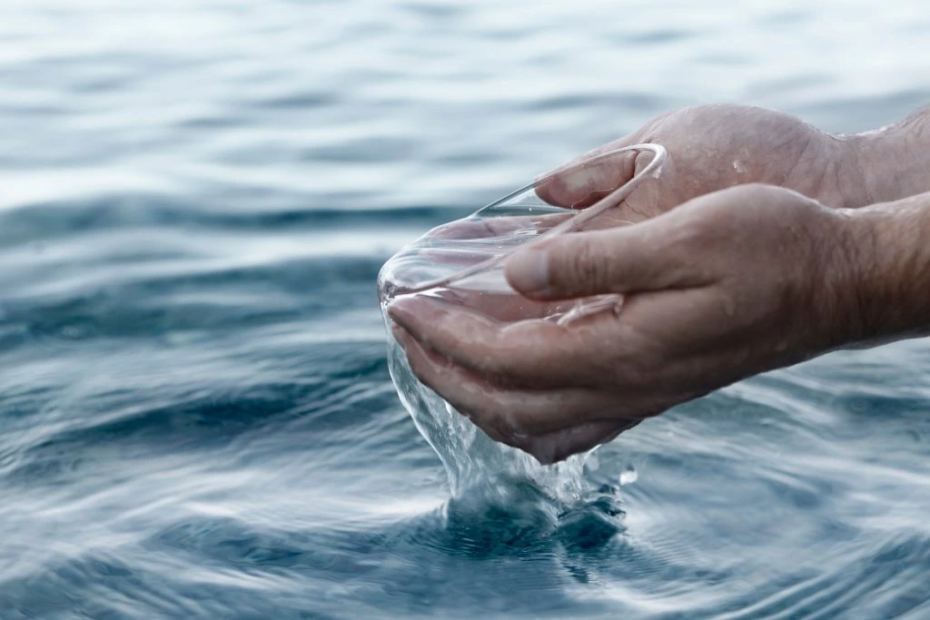 man poring bowl of water 