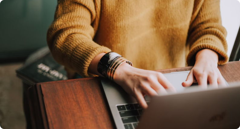 A person using a laptop on the table