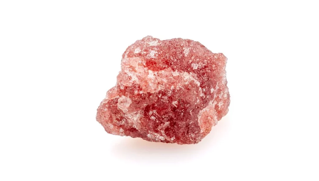 raw strawberry quartz on white background