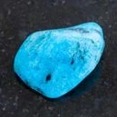 A blue agate on a black granite