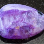 A Charoite on a black granite