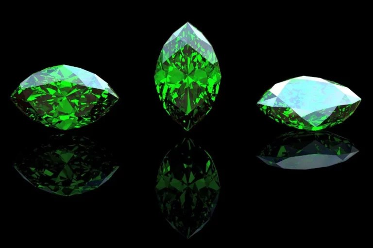 three crystals either identified as emerald or peridot placed right next to each other