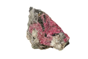 a raw Eudialyte crystal on a white background