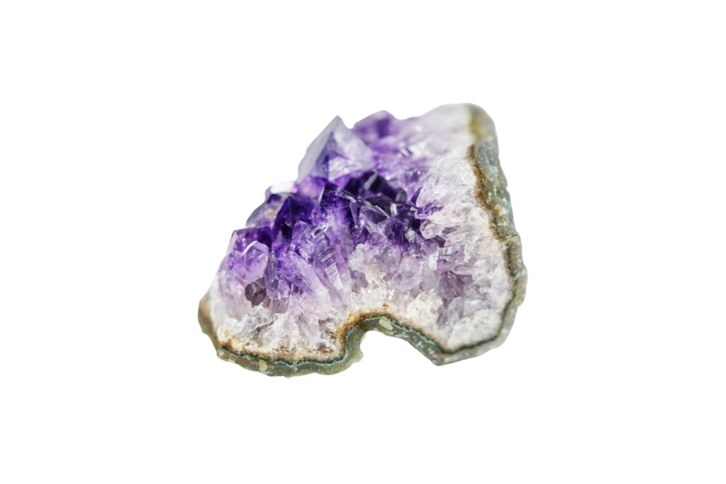 Fragment of an amethysts geode on a white background
