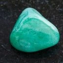 A green Aventurine on a black granite