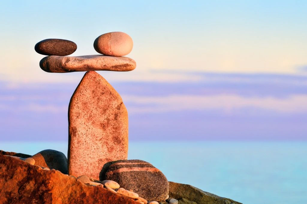 Two stones that are balanced by another stone on the stone