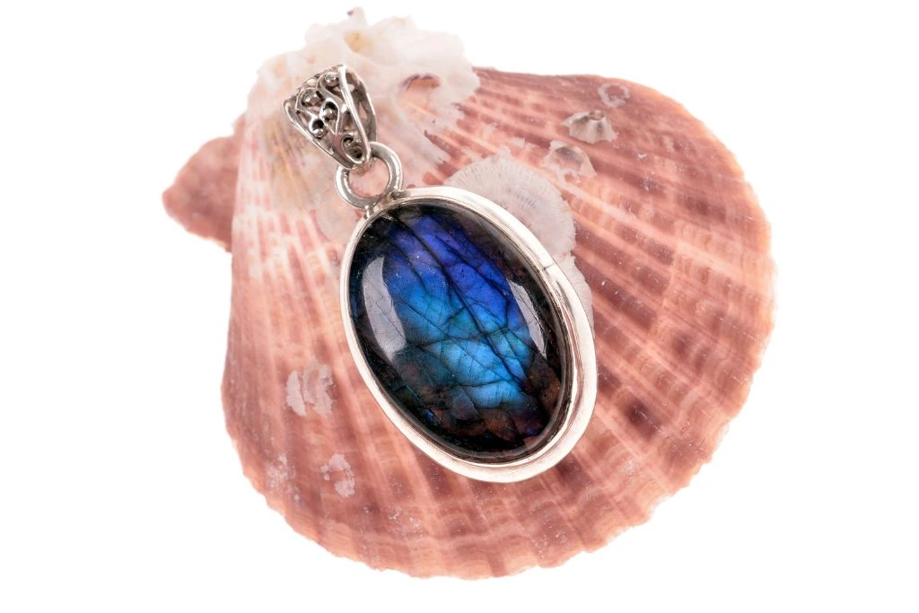 A Labradorite Pendulum Bob on a seashell