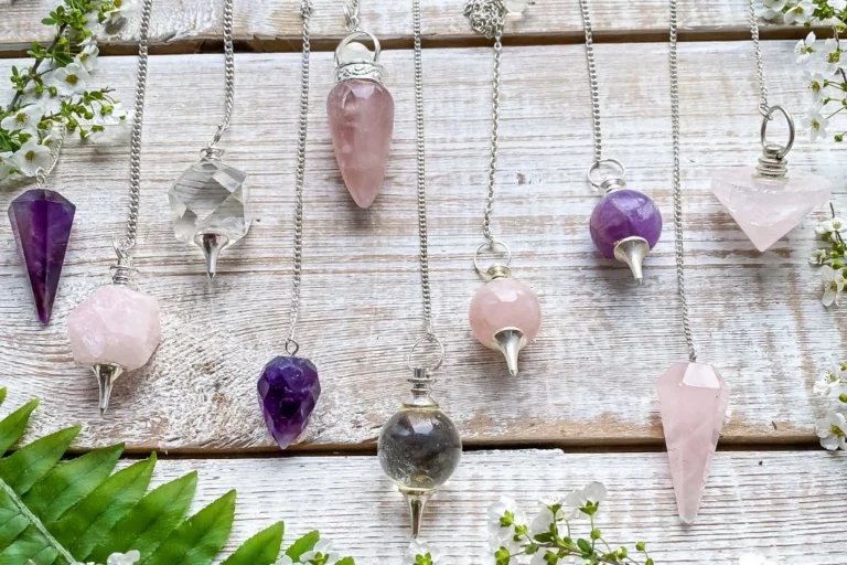 Different kinds of crystal pendulums on a table