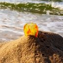 Sunstone crystal placed on beach sand