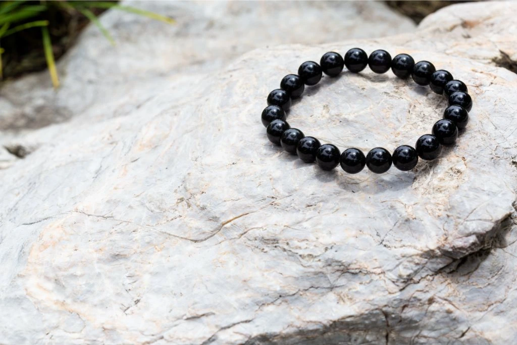 black onyx bracelet on stone background