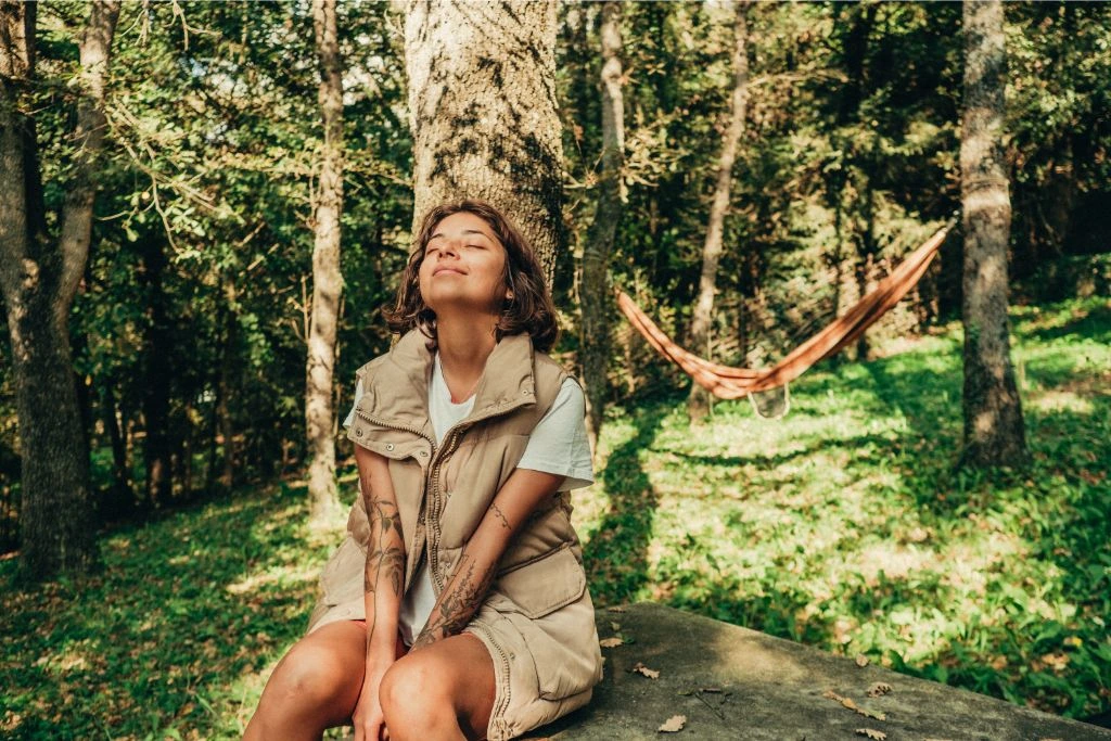 Woman sitting outdoor and enjoying the nature