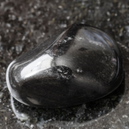 A black obsidian on a black granite