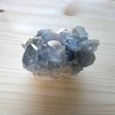 A raw celestite crystal on the table
