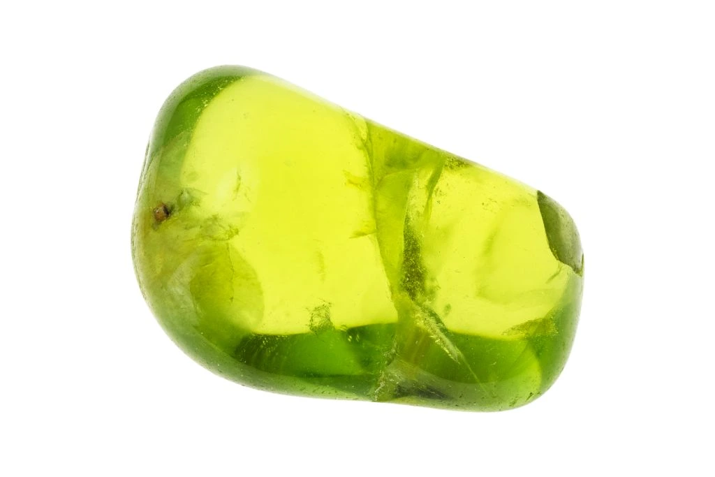 A peridot crystal on a white background