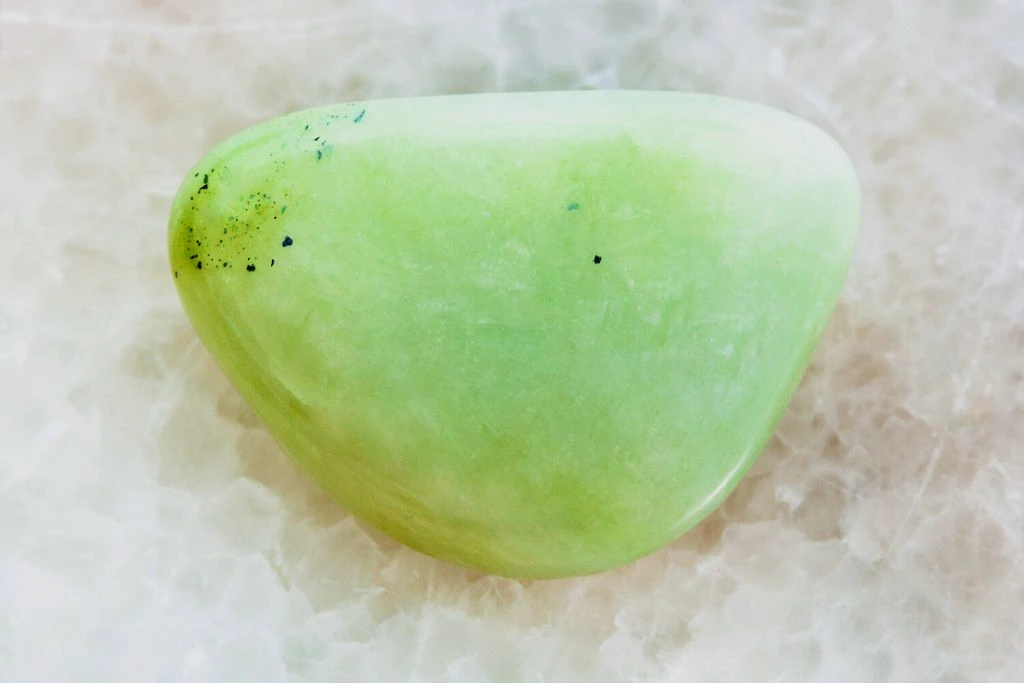 A prasiolite crystal on a white geode crystal