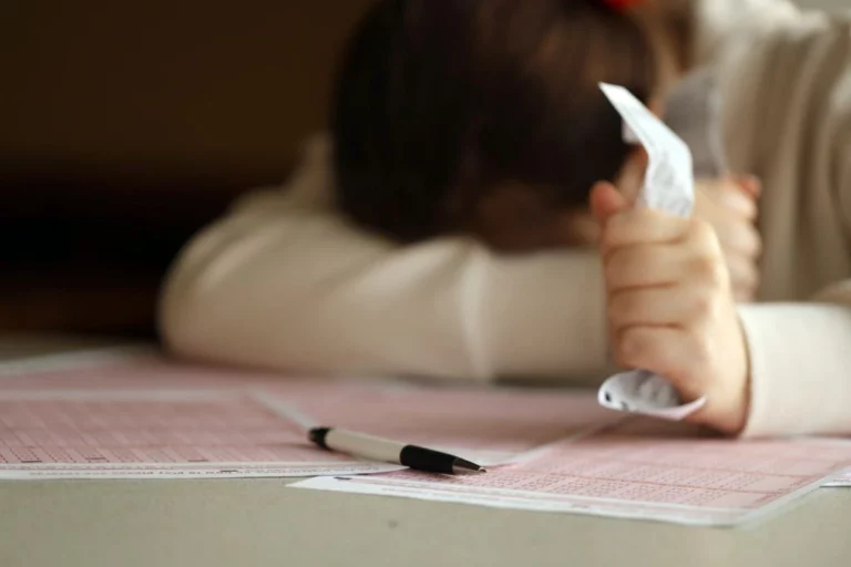 woman lying over her test paper