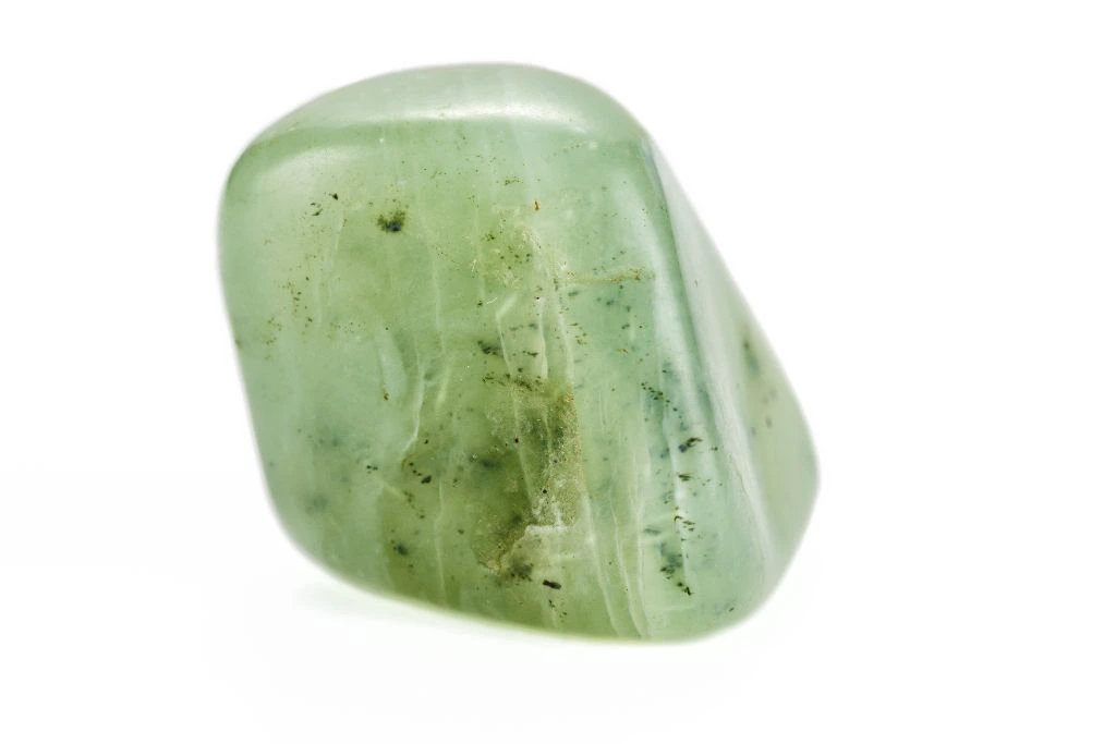 A piece of polished Jade gemstone on white background