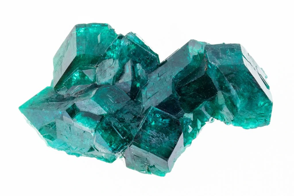 A raw green crystal dioptase on white background