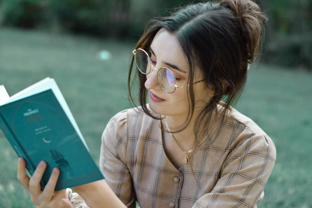 A woman reading a book in nature