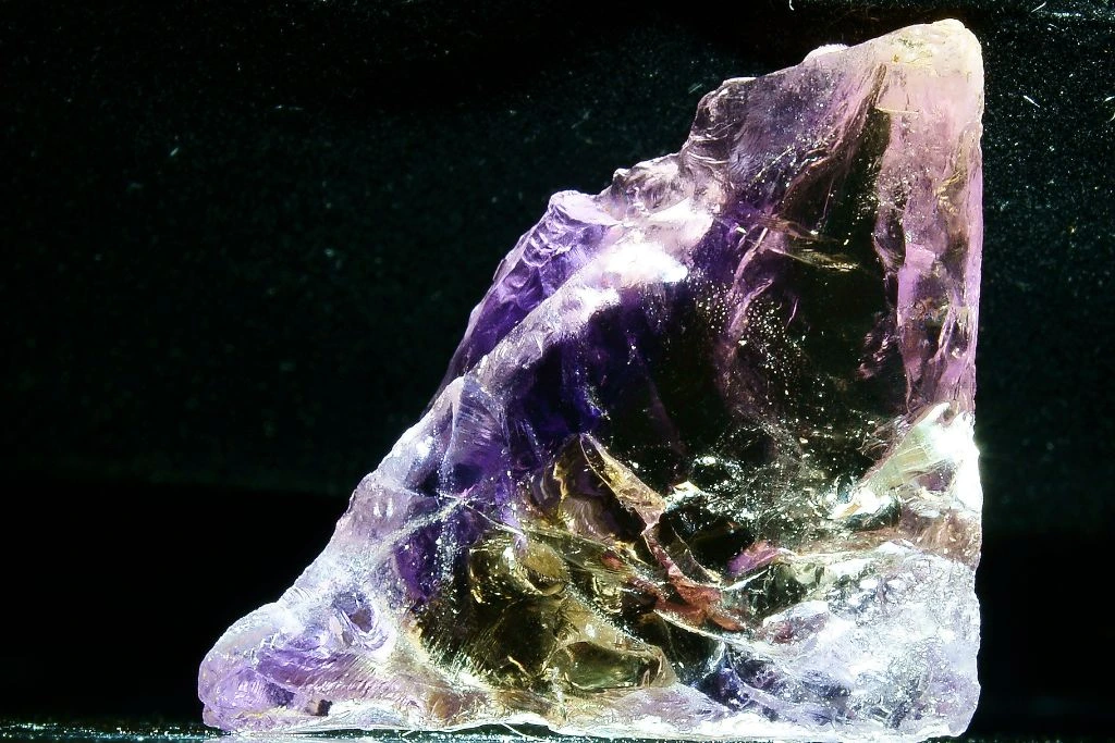 an ametrine crystal on a dark background