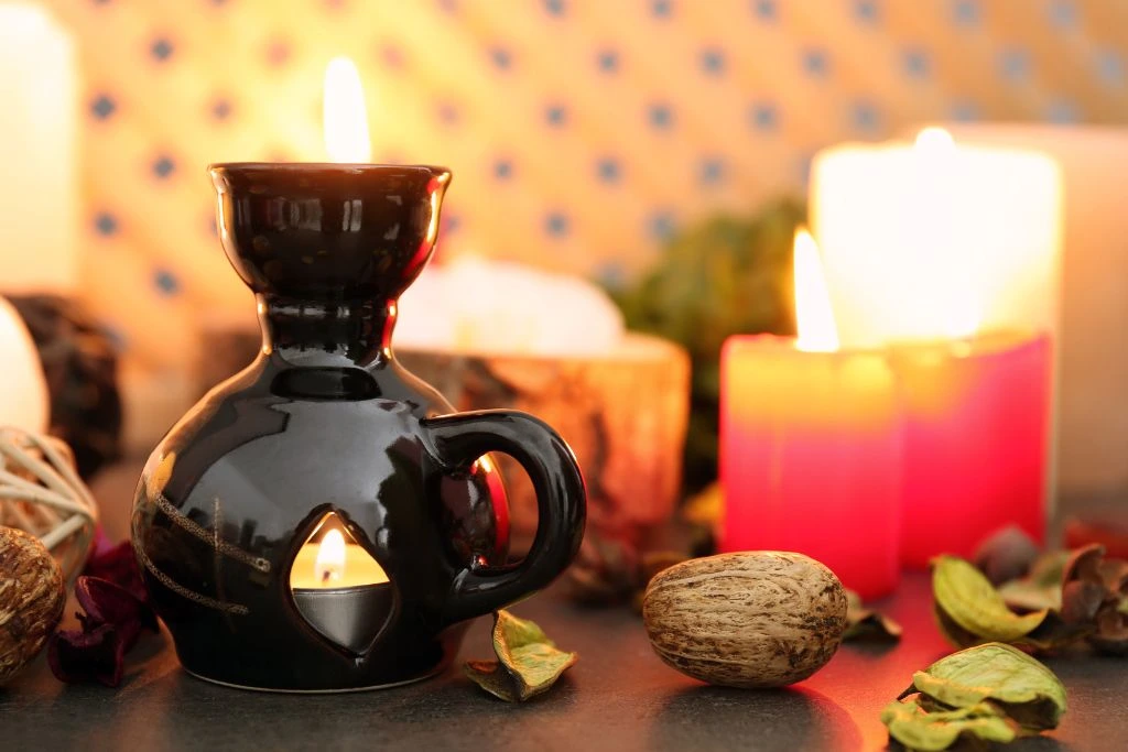 An aroma lamp and candles on the table