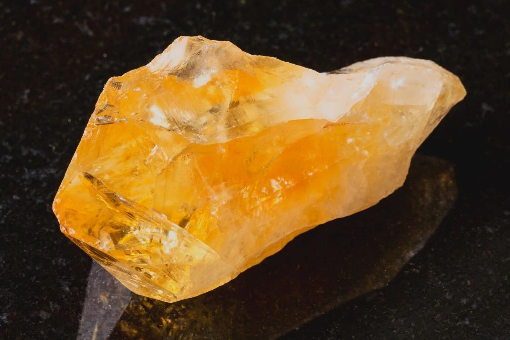 chunk of citrine crystal placed on a black marble table