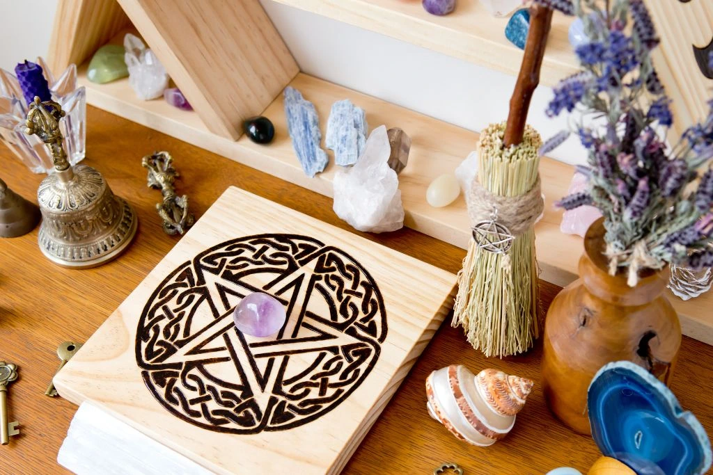 A table full of crystals with other items that is related to a crystal altar