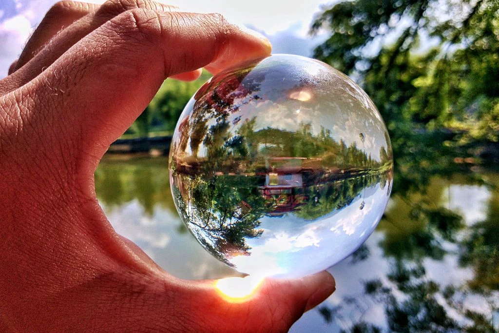 Crystal ball having ray if sunlight and have a blurry lake background