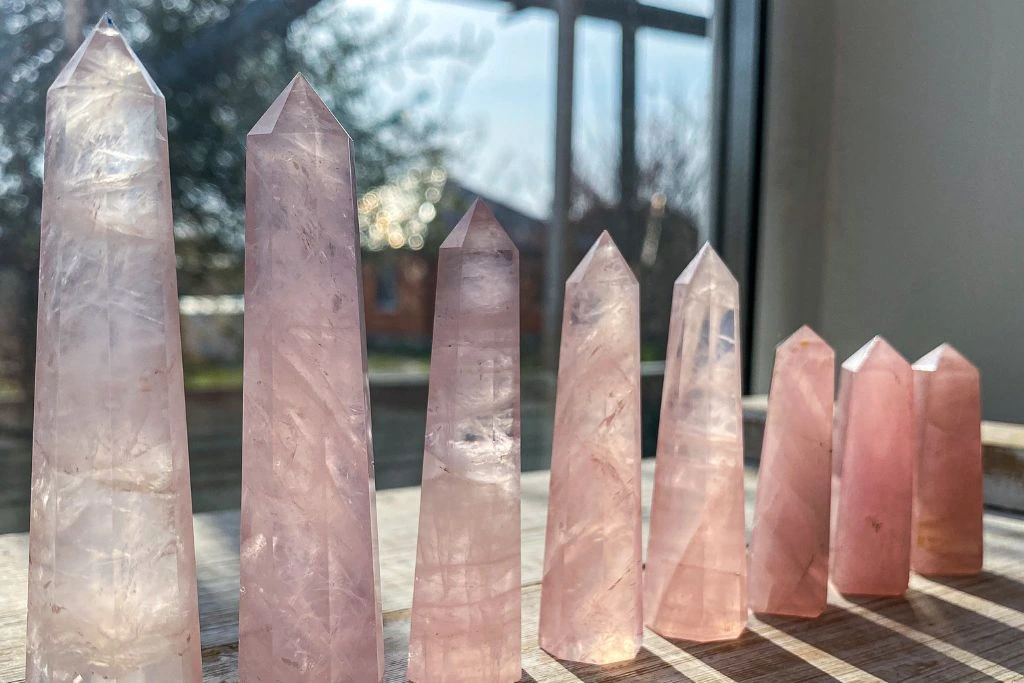 rose quartz tower placed beside a windoe