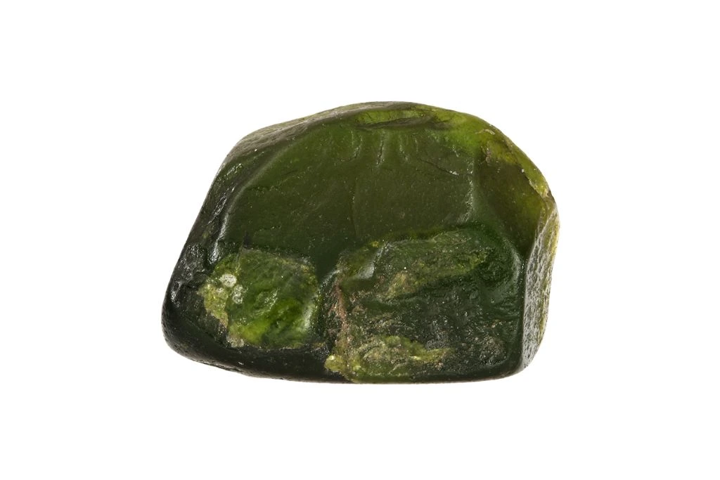 green andalusite green gemstone on white background