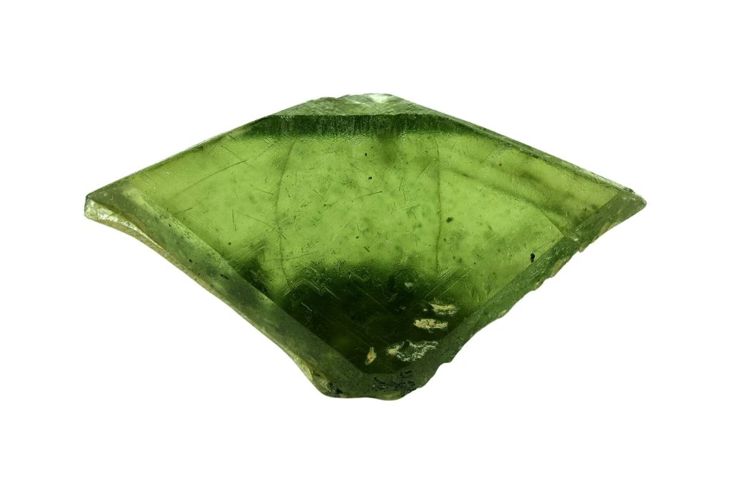 raw green sphene crystal on a white background
