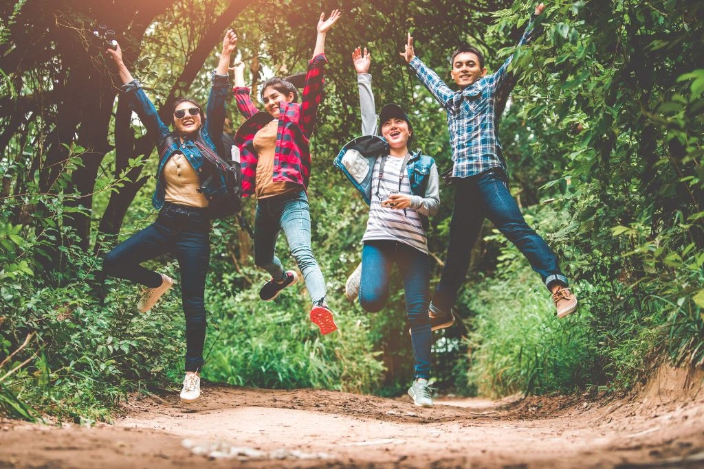 A group of young people smiling in nature