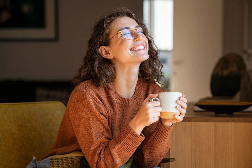 Happy Woman Enjoying Coffee at Home