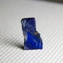 A Lapiz Lazuli crystal on a white cloth