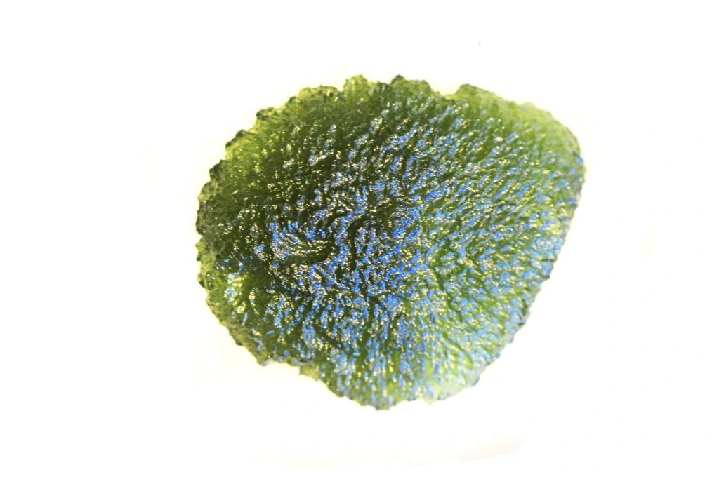 Moldavite green gemstone on white background