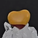 A heart shape mookaite on a rock crystal